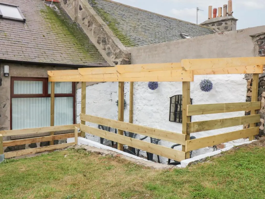 a wooden fence in front of a house at No 9 North St in Fraserburgh