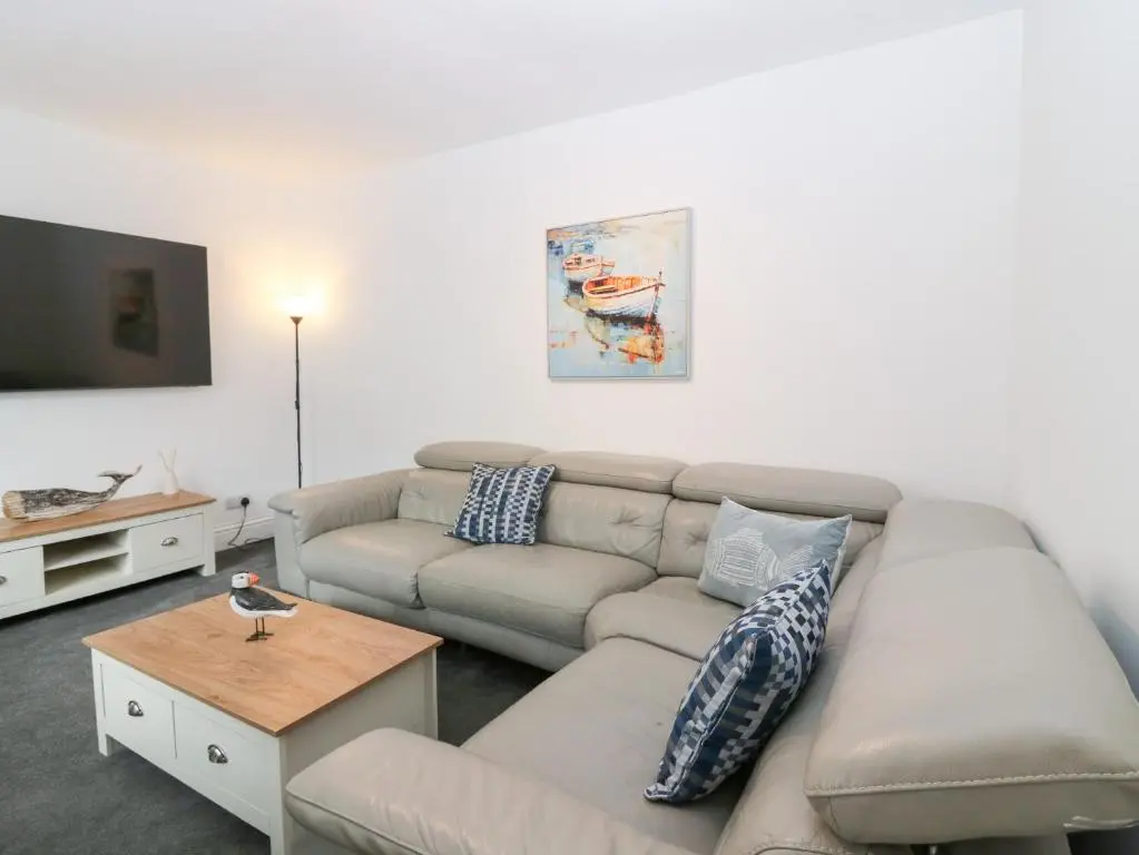 a living room with a couch and a tv at No 9 North St in Fraserburgh