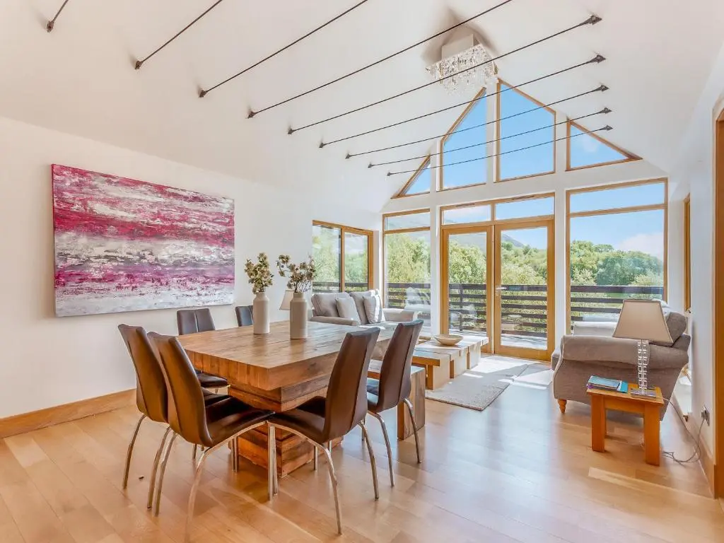 a dining room with a table and chairs at Corrie Burn Villa in Ullapool