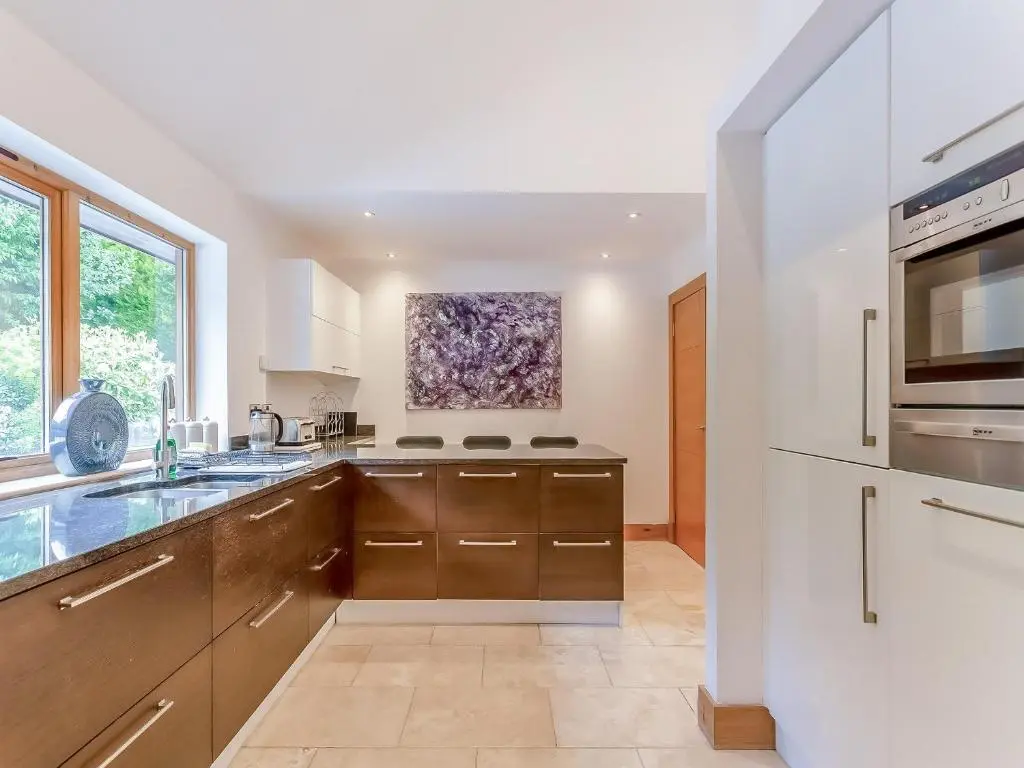 a kitchen with a sink and a microwave at Corrie Burn Villa in Ullapool