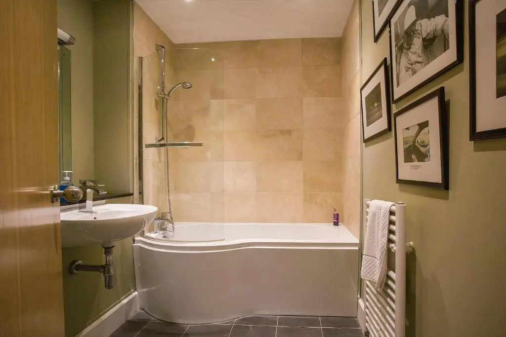 a bathroom with a bath tub and a sink at The Livingstone Loch Ness OS9 in Fort Augustus