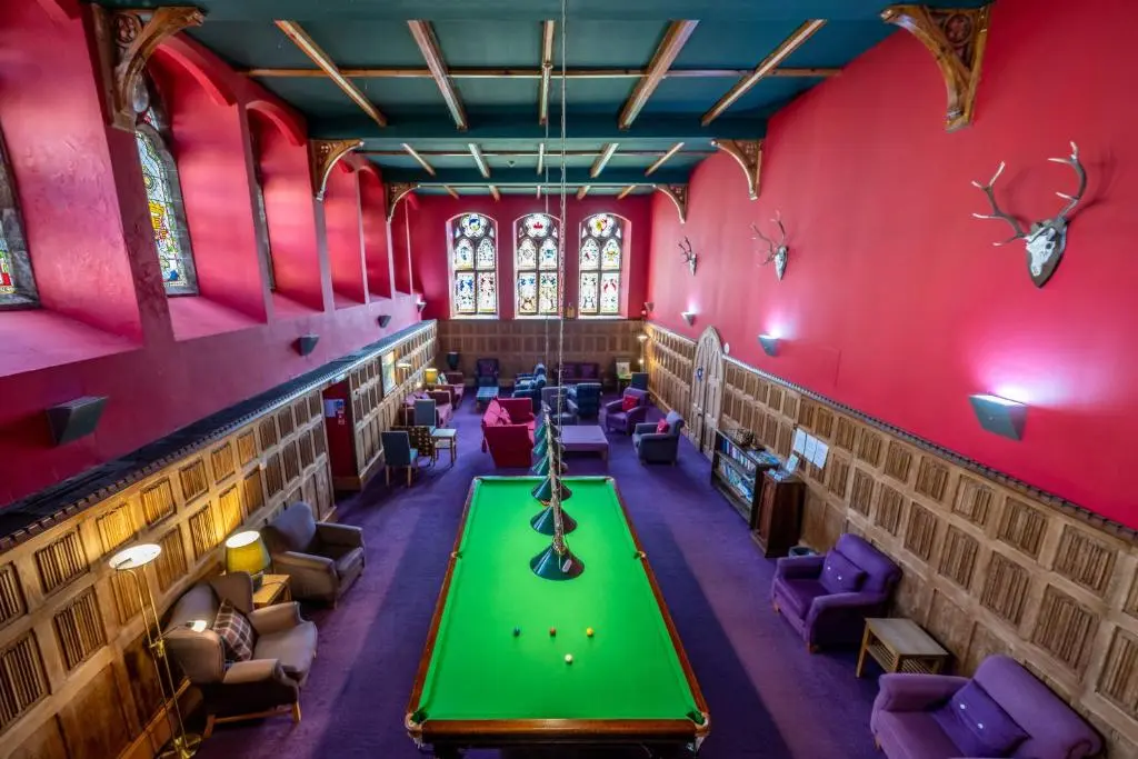 a room with a green table and purple chairs at The Livingstone Loch Ness OS9 in Fort Augustus