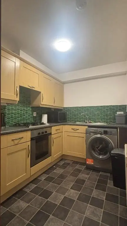 a kitchen with a washer and a washing machine at Bright 2 Bed Corner Flat - Great Location in South Kessock