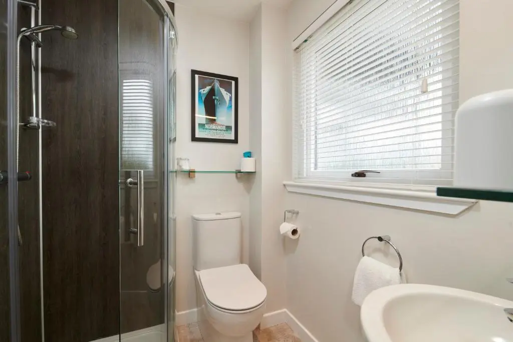 a bathroom with a toilet and a sink and a shower at By the Brae in Inverness