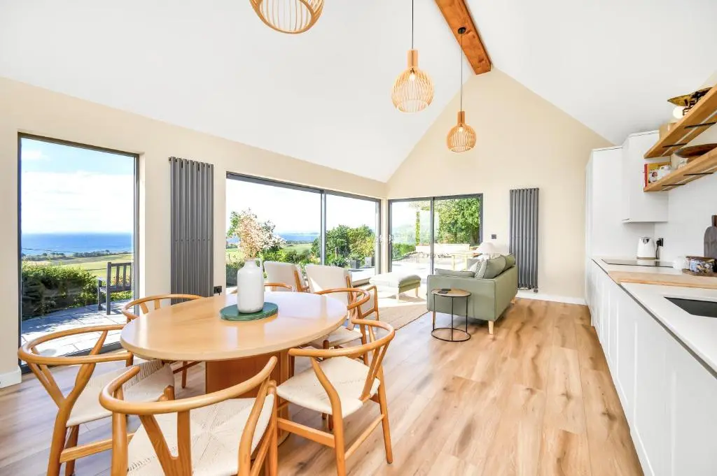 a kitchen and dining room with a table and chairs at The Top House, Lothmore in Helmsdale