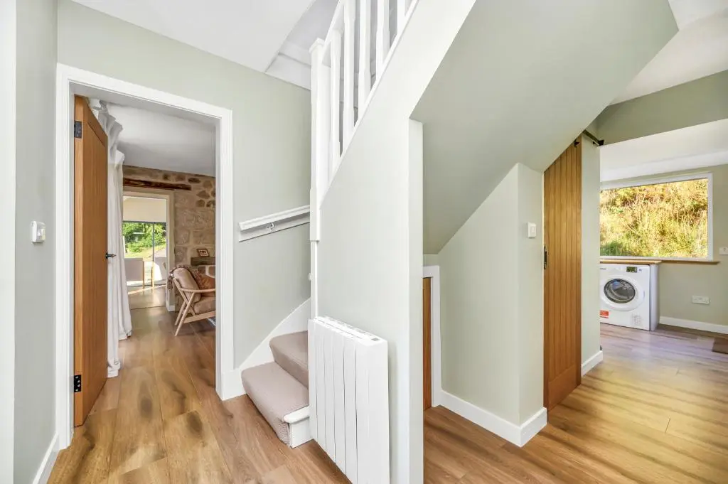 an open hallway with white walls and wood floors at The Top House, Lothmore in Helmsdale