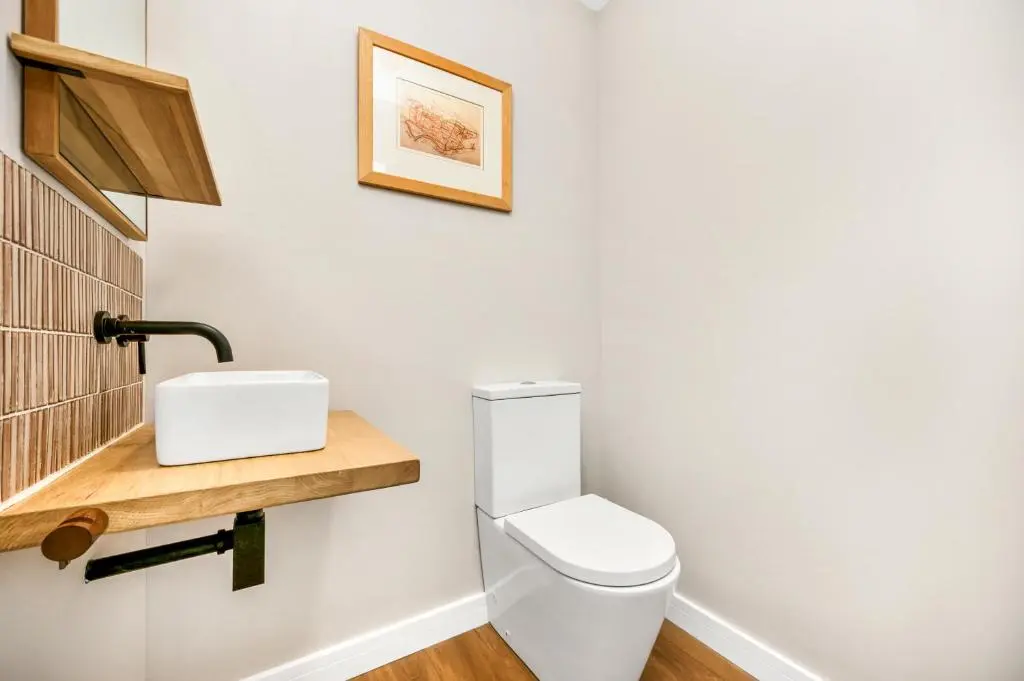 a bathroom with a white toilet and a sink at The Top House, Lothmore in Helmsdale