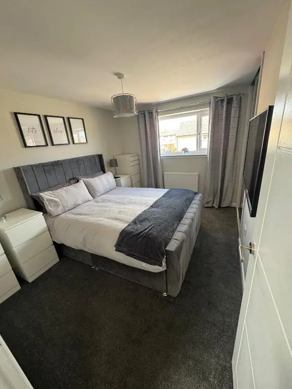 a bedroom with a large bed and a window at Inward Oasis Relax and unwind in Buckie
