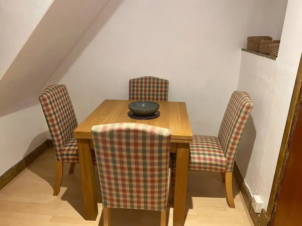 a dining room table with chairs and a bowl on it at Wee Braemoray, Portessie, Buckie,Moray in Portessie