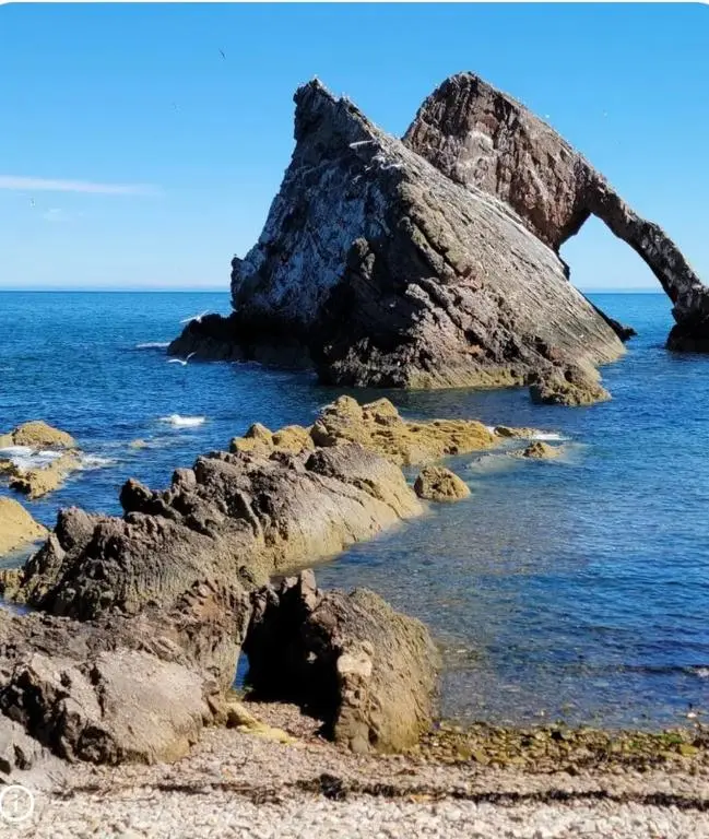 a rock formation in the water on a beach at Wee Braemoray, Portessie, Buckie,Moray in Portessie