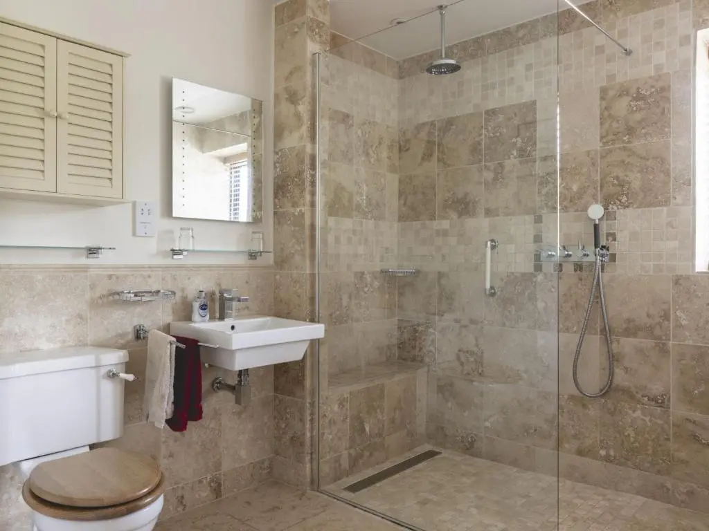a bathroom with a shower and a toilet and a sink at Phils House in Lairg