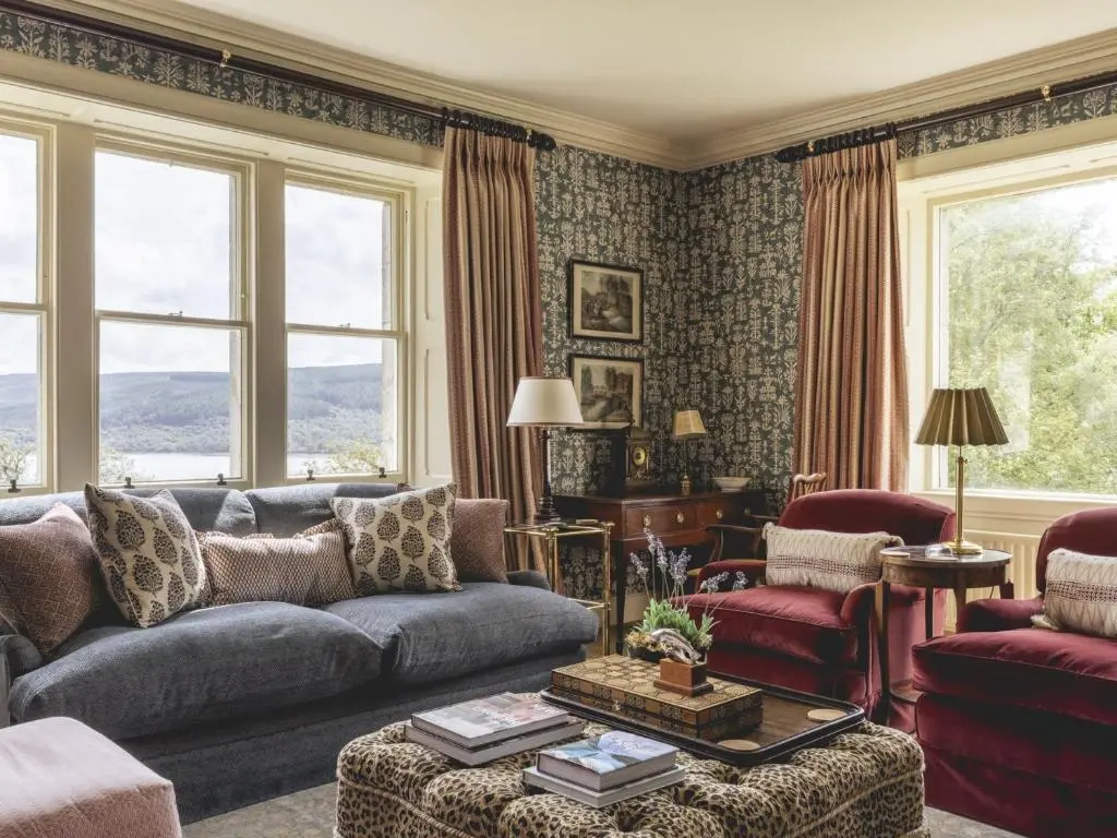 a living room with a couch and chairs at Lairg Lodge in Lairg