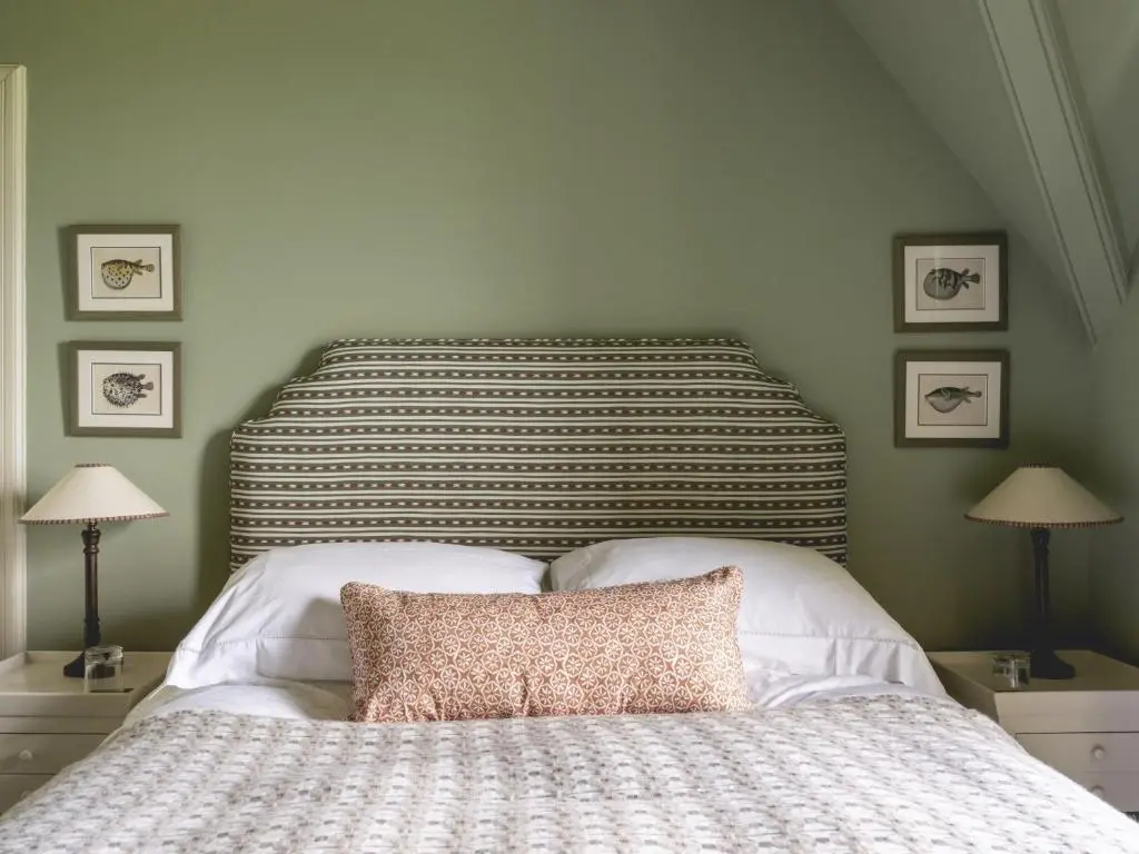 a bedroom with a bed with two lamps and two tables at Lairg Lodge in Lairg