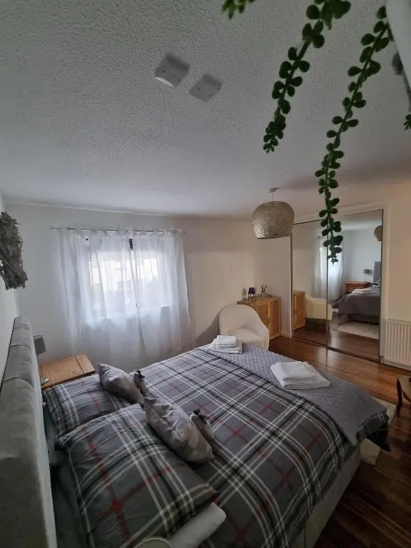 a bedroom with a bed with two birds laying on it at Highland Breeze Inverness in Inverness