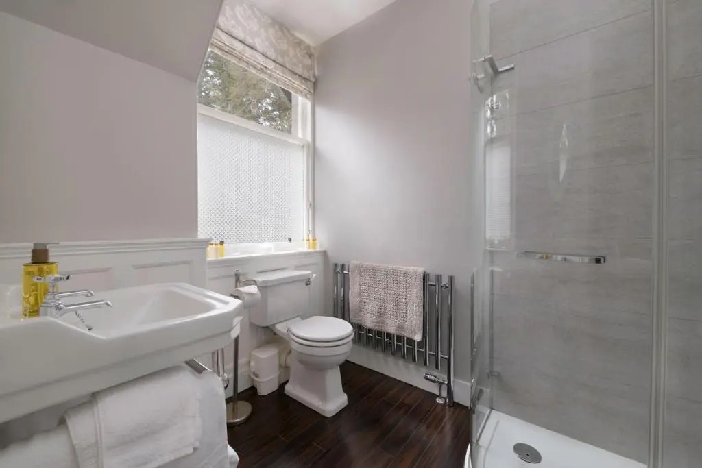 a bathroom with a toilet and a sink and a shower at Lys-Na-Greyne Country House in Aboyne