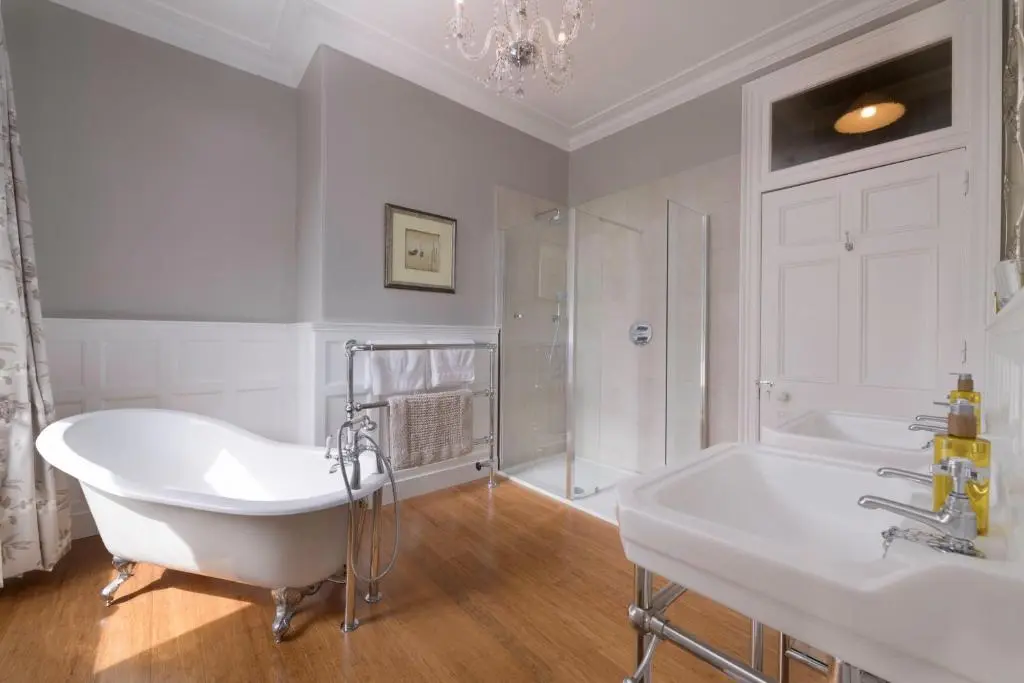 a white bathroom with a tub and a sink at Lys-Na-Greyne Country House in Aboyne