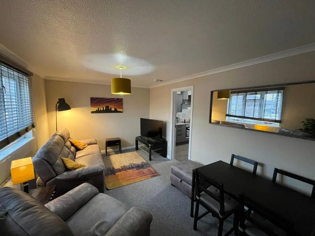 a living room with a couch and a table at 24 Two bedroom apartment Culloden Inverness Highlands in Culloden