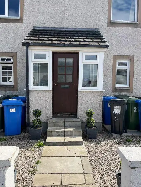 a house with a brown door and some trash cans at 24 Two bedroom apartment Culloden Inverness Highlands in Culloden