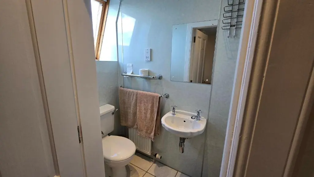 a small bathroom with a toilet and a sink at The Pitfour Arms Hotel in Mintlaw