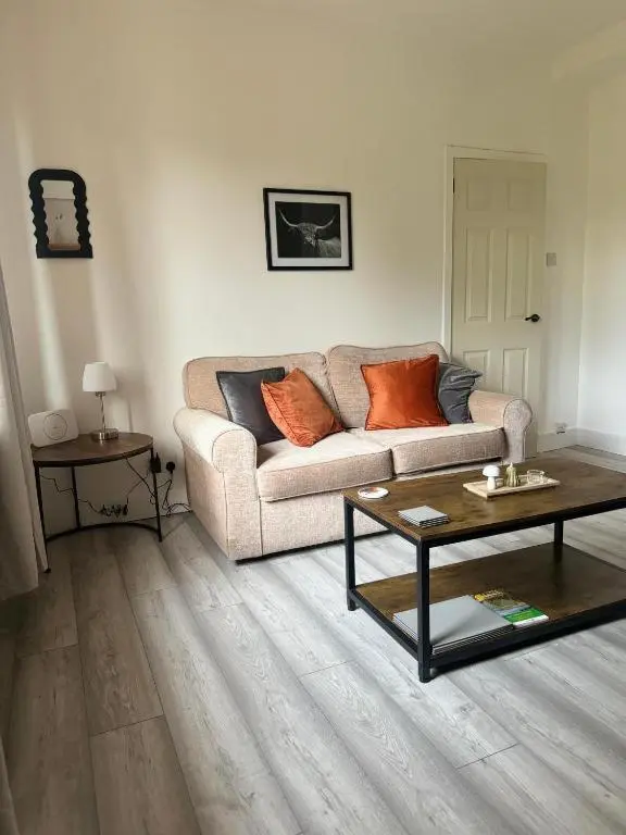 a living room with a couch and a table at Stephen's Brae Apartment, Inverness City Centre in Inverness