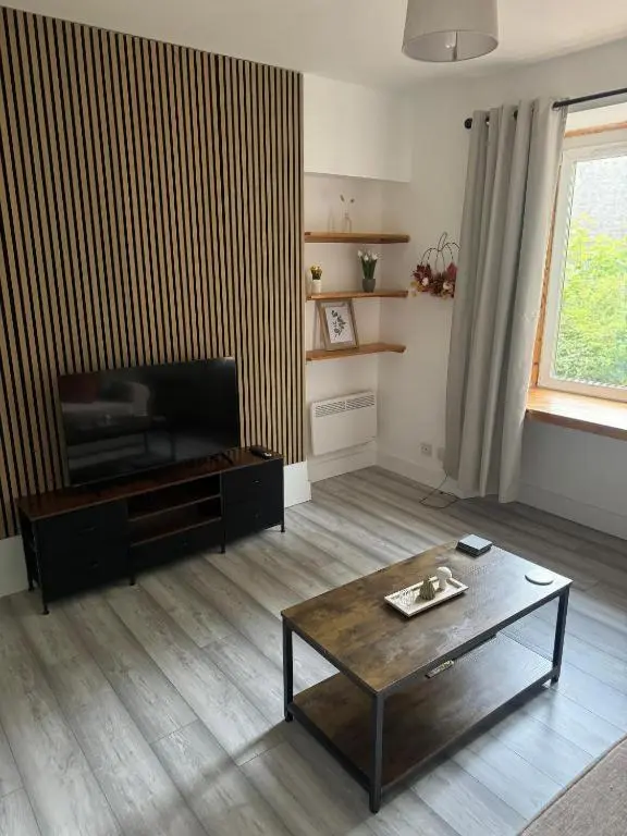 a living room with a television and a coffee table at Stephen's Brae Apartment, Inverness City Centre in Inverness
