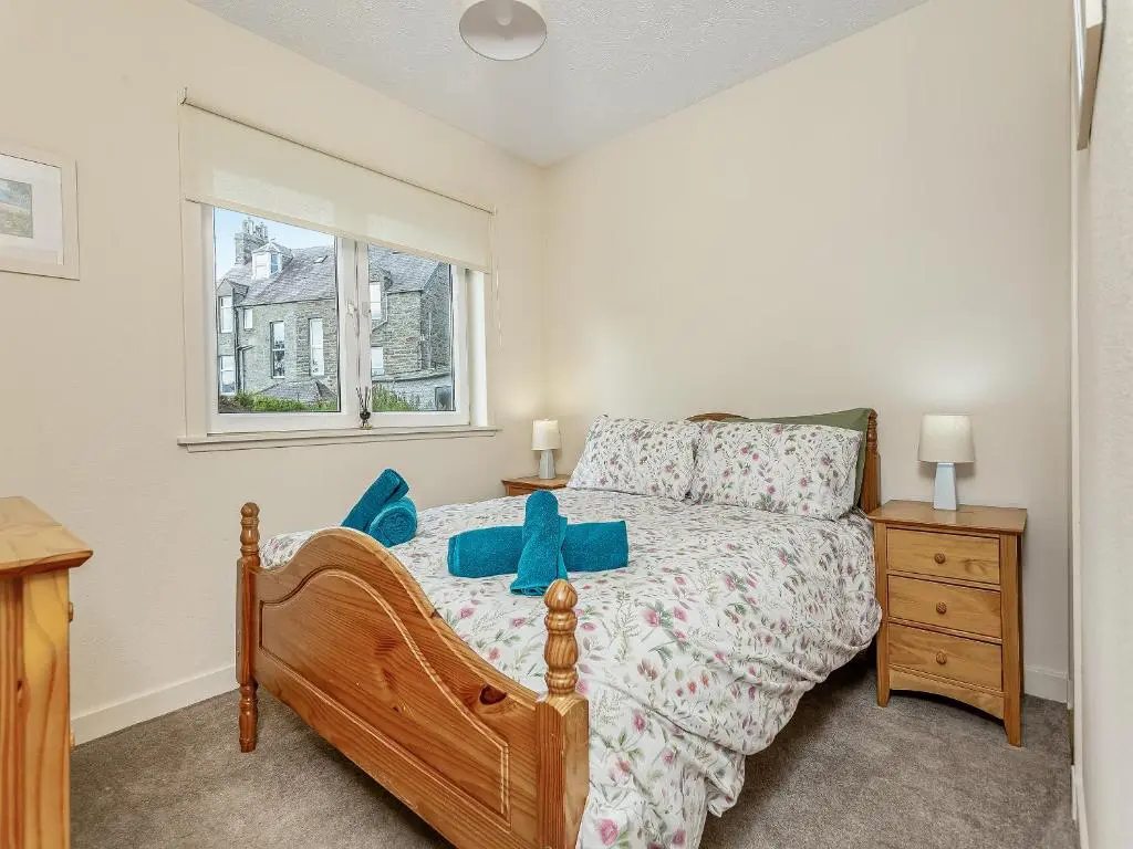 a bedroom with a bed and a window at Tanera in Wick