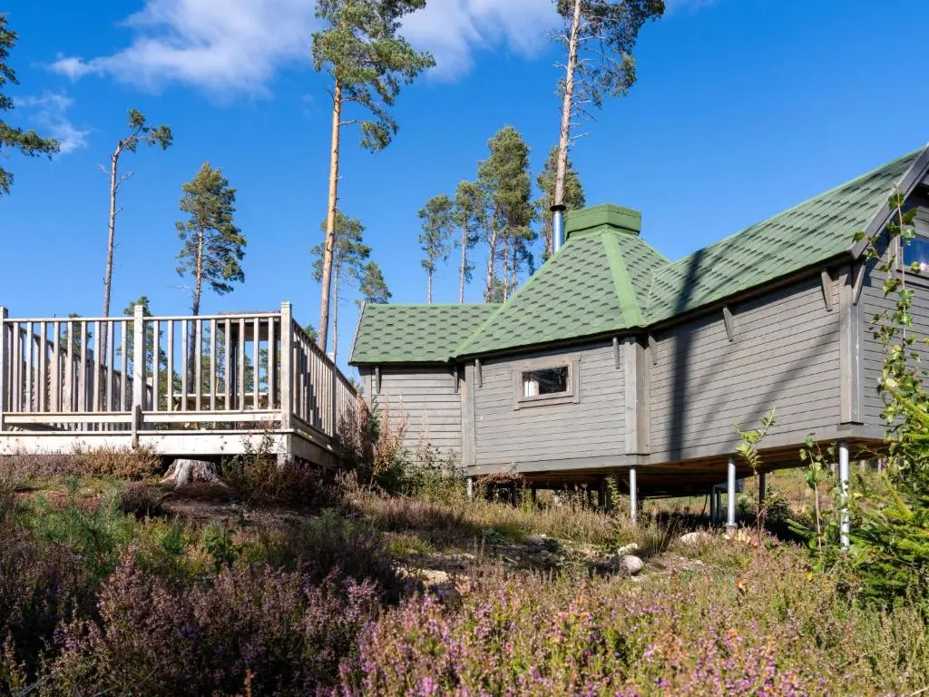a house with a green roof and a wooden deck at Apartment Ghillie's Bothy by Interhome in Coldstone