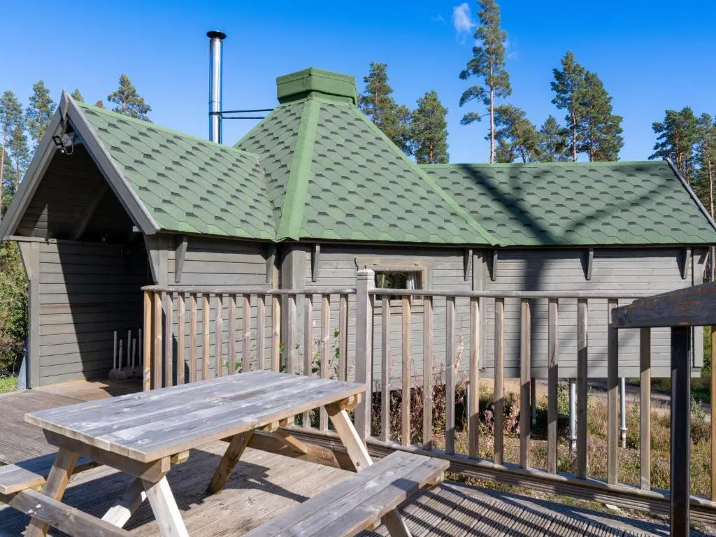 a wooden building with a green roof and a picnic table at Apartment Ghillie's Bothy by Interhome in Coldstone