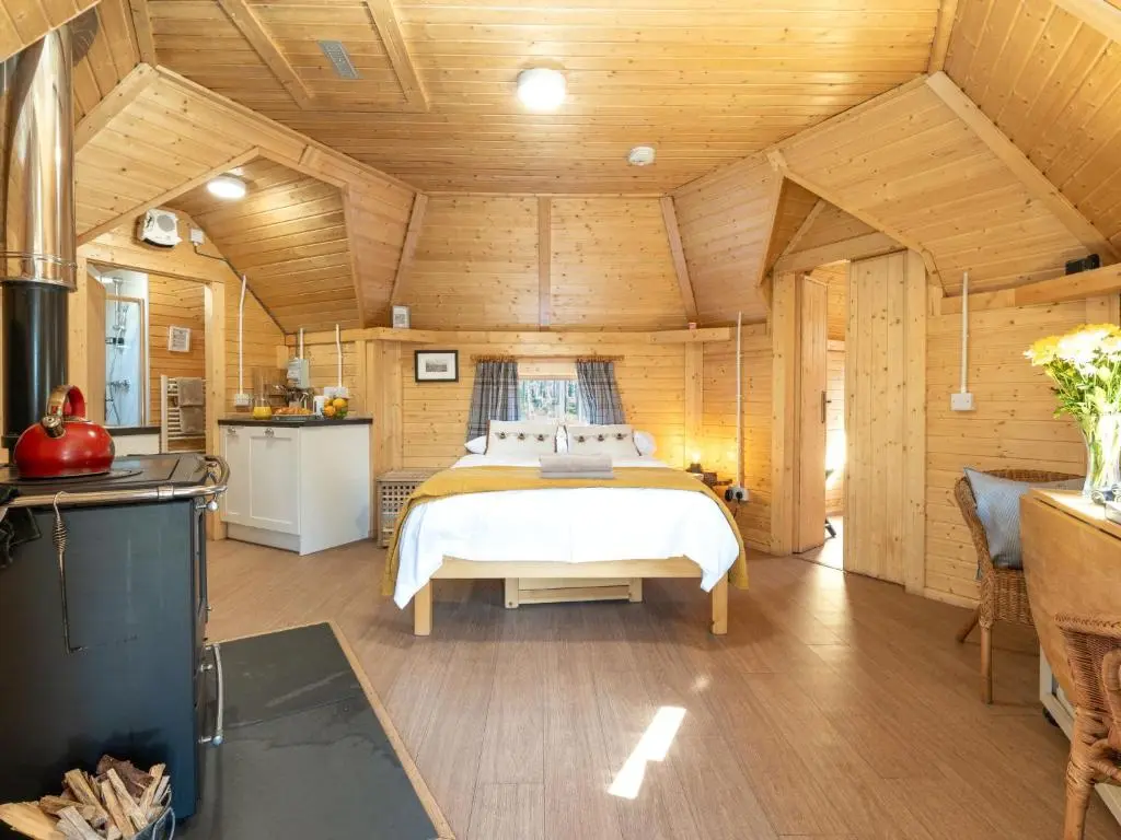 a bedroom with a bed in a wooden room at Apartment Ghillie's Bothy by Interhome in Coldstone