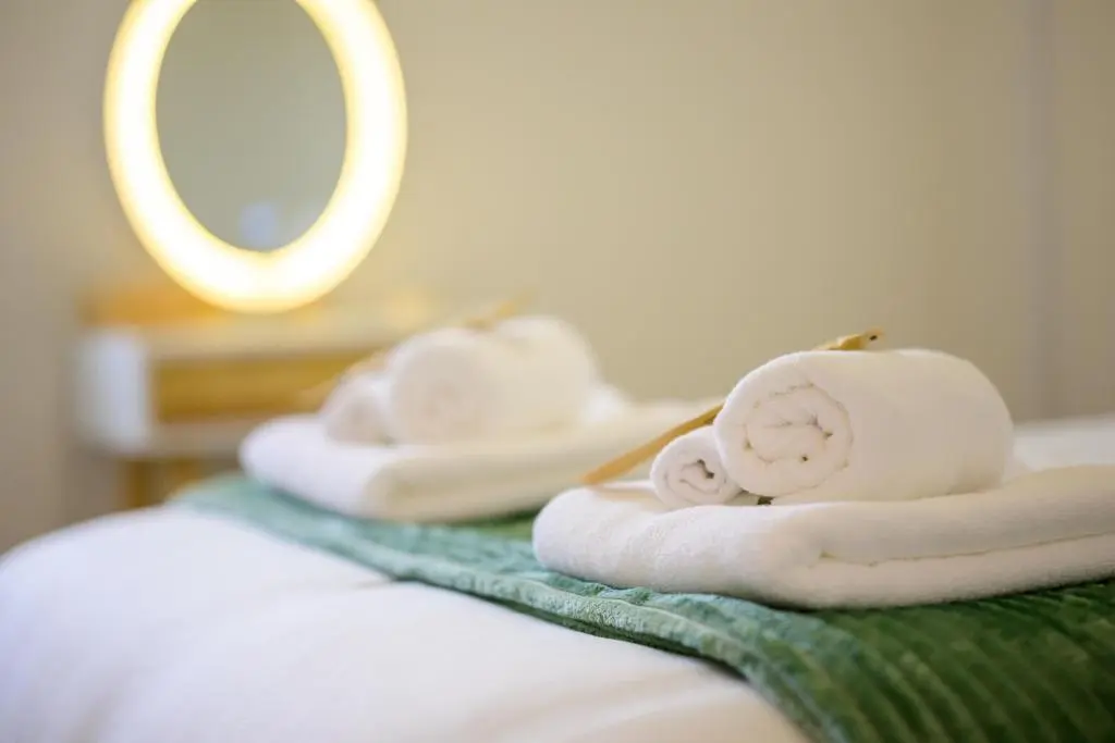a group of towels sitting on top of a bed at 2 Bed Property, Beauly in Beauly