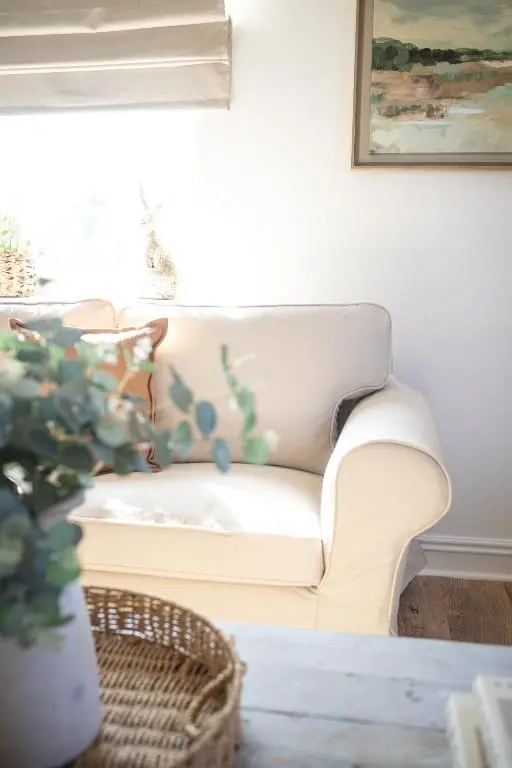 a white couch in a living room with a plant at Lillymont Apartment - Inverness City Centre in Inverness