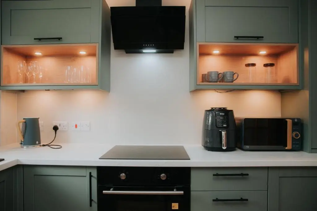a kitchen with a microwave and a laptop on a counter at Spacious Flat with Parking Great Inverness Base in Inverness