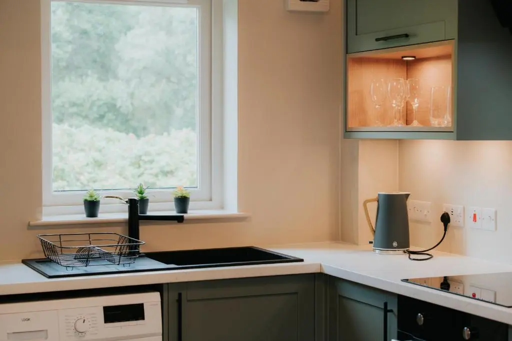 a kitchen with a sink and a window at Spacious Flat with Parking Great Inverness Base in Inverness