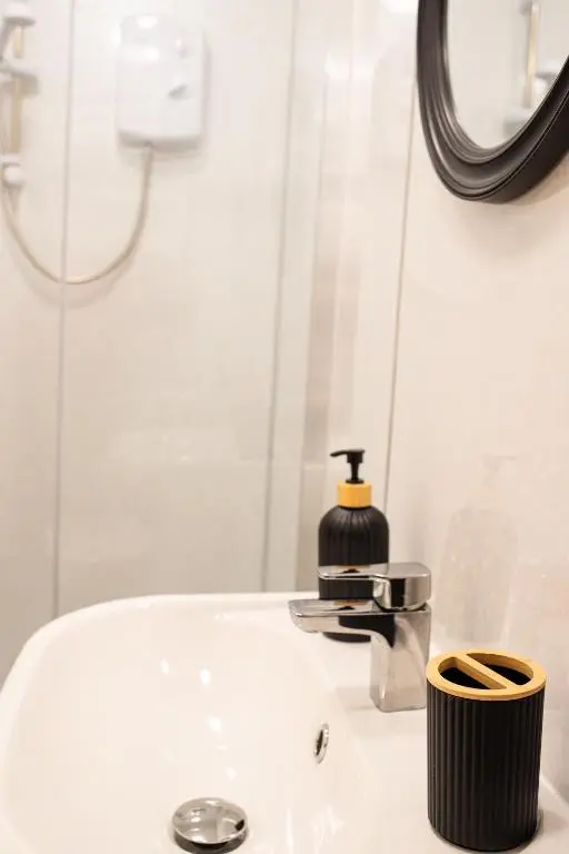 a bathroom sink with a soap dispenser on it at Baron Taylor Stays in Inverness