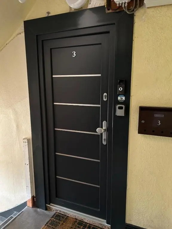 a black door with the number thirty three on it at Chloes Holiday Apartments in Inverness