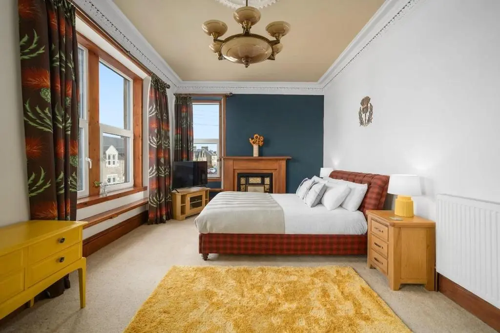 a bedroom with a bed and a television in it at Crown Jewel - Inverness City Centre in Inverness