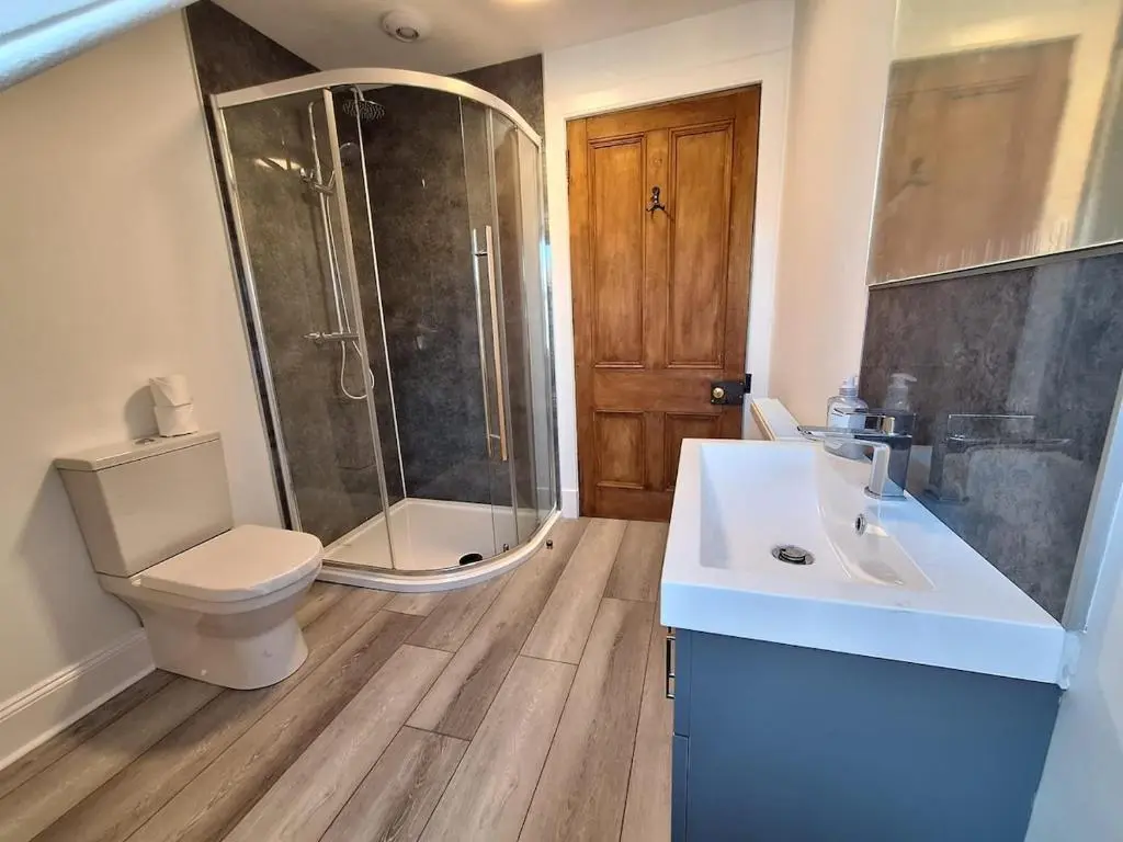 a bathroom with a shower and a toilet and a sink at Crown Jewel - Inverness City Centre in Inverness