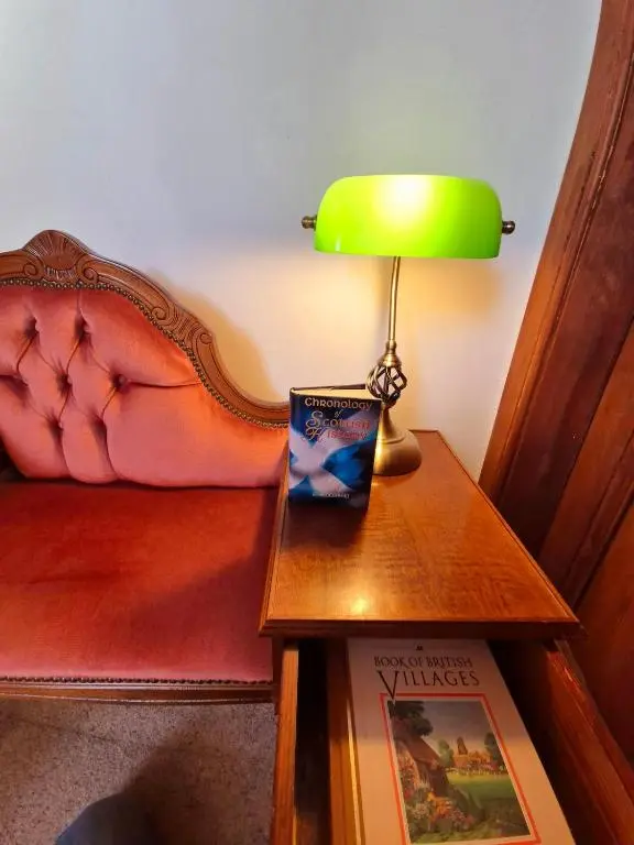 a green lamp sitting on a table next to a bed at Crown Jewel - Inverness City Centre in Inverness