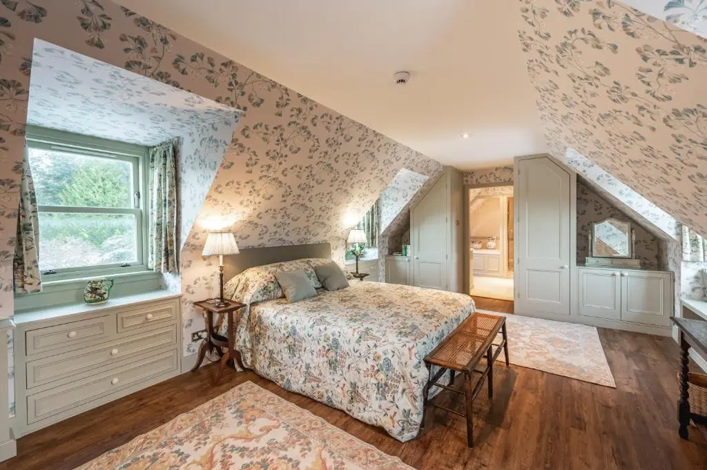 a bedroom with a bed and a window at Grieves Cottage Balnagown Estate in Kildary