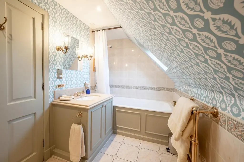 a bathroom with a sink and a bath tub at Grieves Cottage Balnagown Estate in Kildary