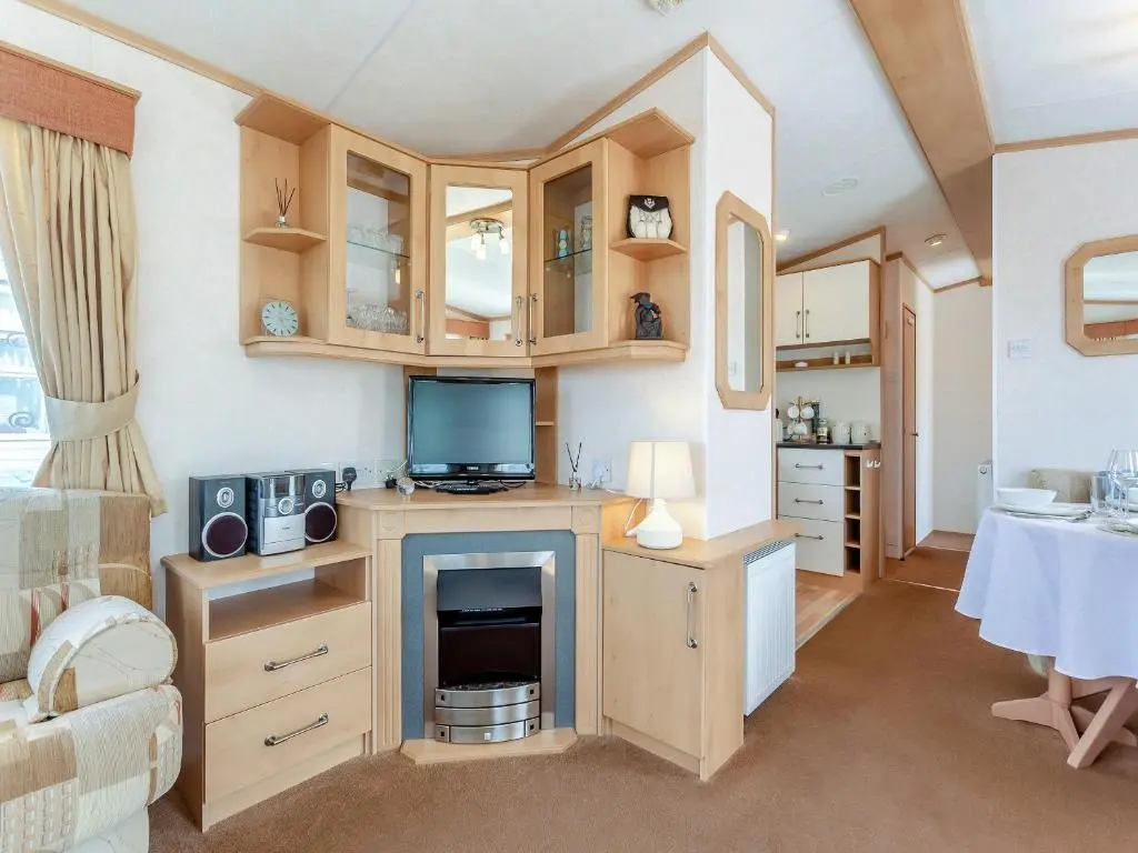 a living room with a tv and a fireplace at Sunny Firth in Tain