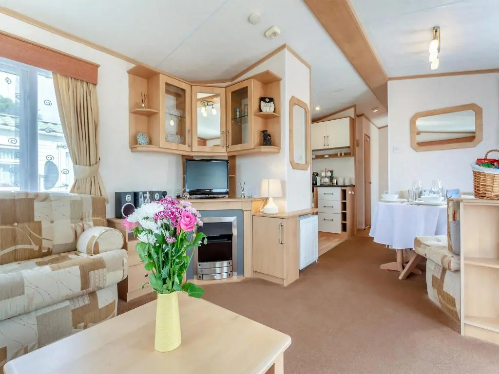 a living room with a vase of flowers on a table at Sunny Firth in Tain