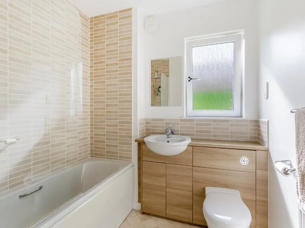 a bathroom with a toilet and a sink and a bath tub at Kincraig Apartment in Inverness