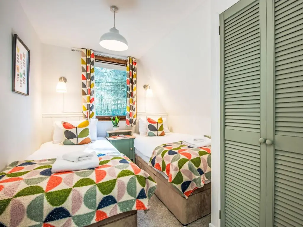 a bedroom with two beds and a window at Chalet Pine Needle Lodge by Interhome in Spean Bridge