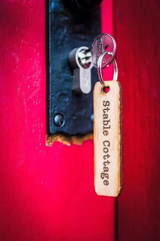a padlock is attached to a red door at Holiday Home Highland Cottage by Interhome in Drumnadrochit