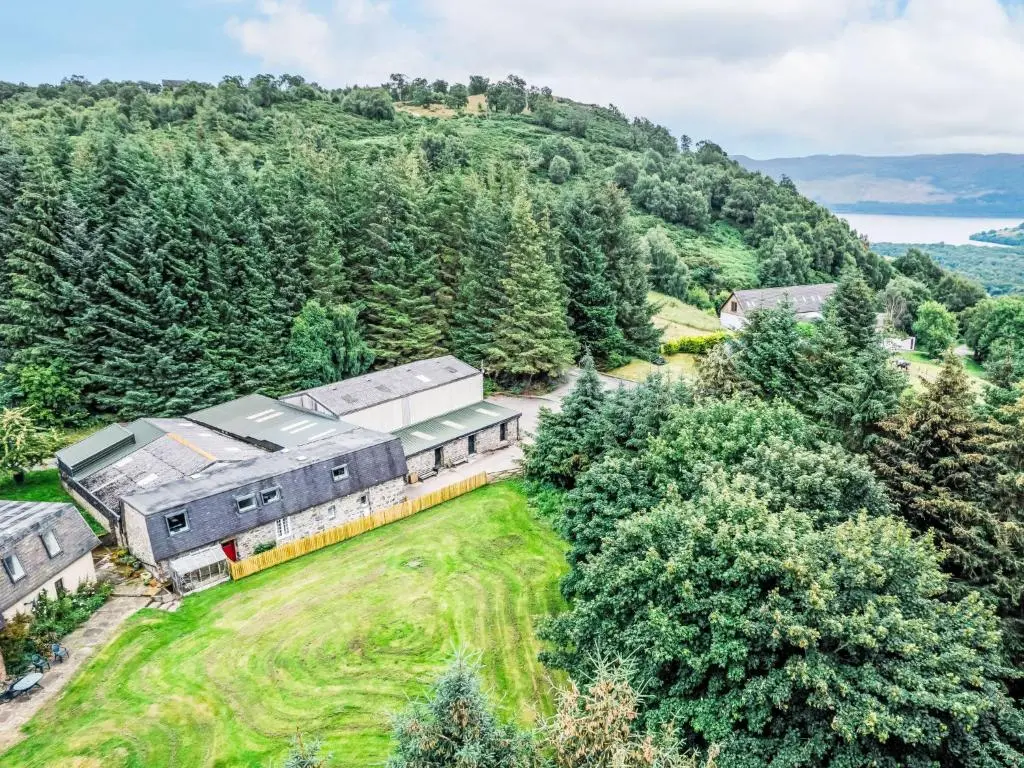 an aerial view of a farm with a train at Holiday Home Highland Cottage by Interhome in Drumnadrochit