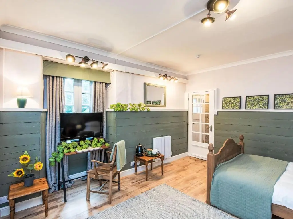 a bedroom with a bed and a tv in a room at Holiday Home Highland View by Interhome in Drumnadrochit