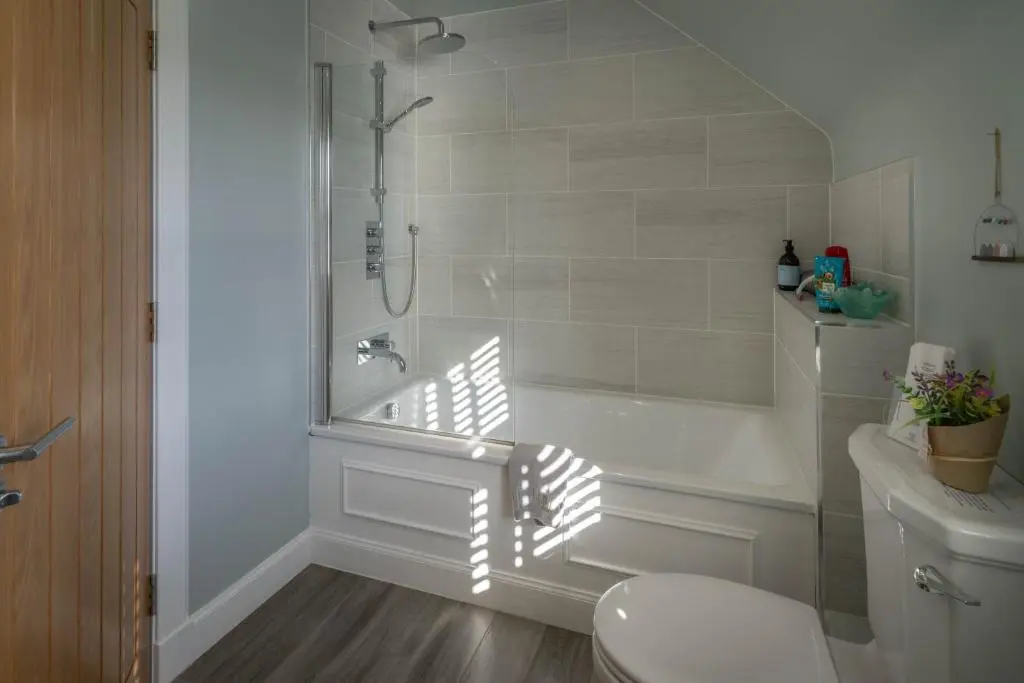 a white bathroom with a tub and a toilet at Glen Tilt House in Bridge of Tilt