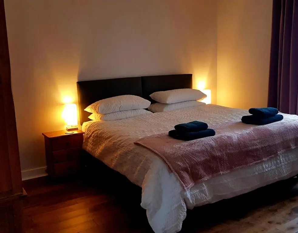a bedroom with a bed with two towels on it at Institution Road in Elgin
