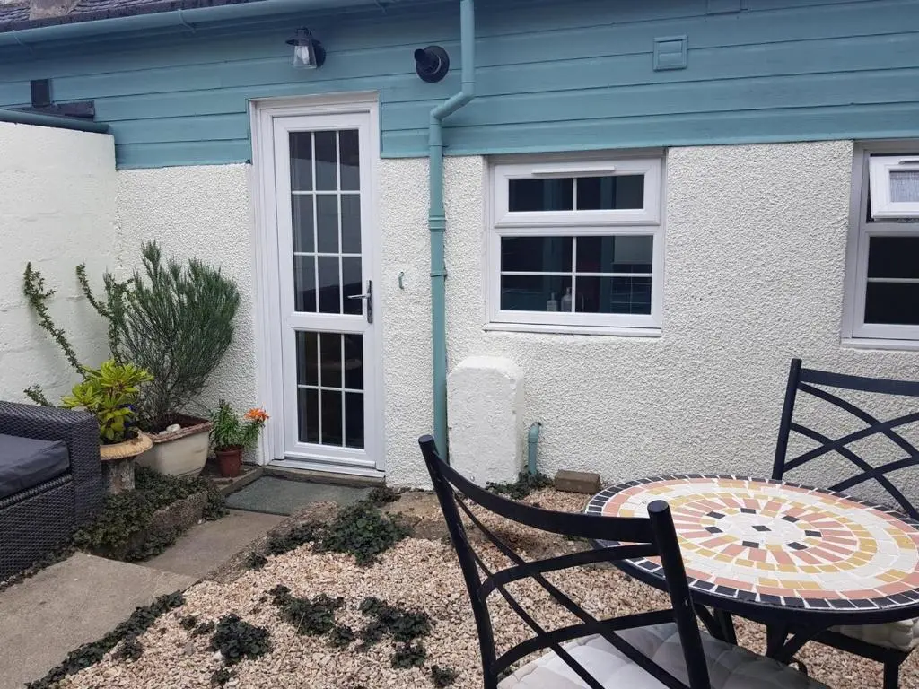 a table and chairs in front of a house at Institution Road in Elgin